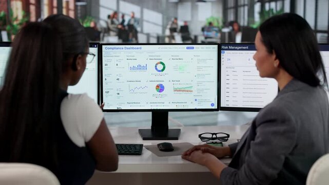 Compliance Manager Reviews Regulatory Dashboard While Coaching Team