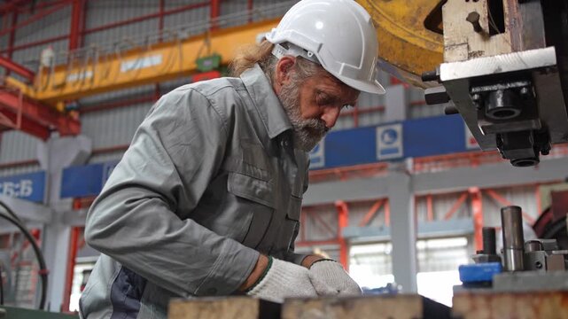 Industrial worker engaged in precision tasks at manufacturing facility focused environment professional viewpoint craftsmanship concept