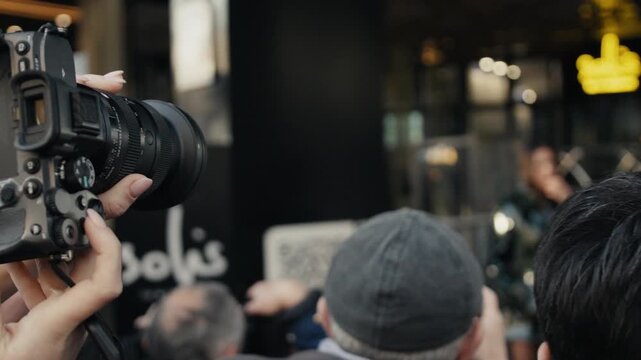 Photographers and paparazzi taking pictures of a celebrity