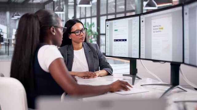 Two Women Reviewing Cybersecurity Policy Document