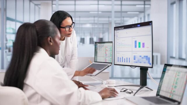 Two Women Working Together On Medical Coding Audit