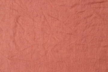 Fototapeta premium Texture of a fabric in warm tones with a soft and crinkled appearance on display in a neutral setting