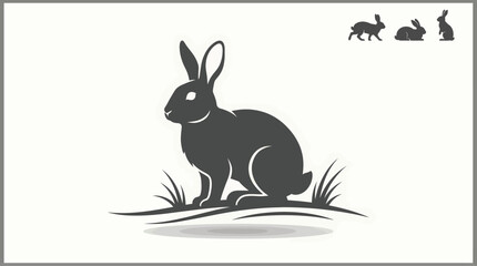 Obraz premium black rabbit silhouette sitting on grass with smaller rabbit silhouettes