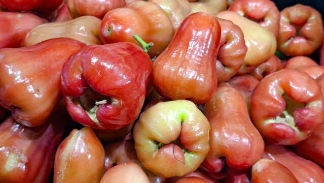 Fresh sweet rose apple fruits stacked at a traditional tropical fruit market in Thailand for healthy organic lifestyle