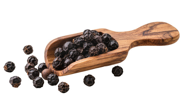 Wooden scoop overflowing with black peppercorns and scattered around