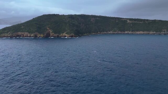 Cinematic panoramic drone footage capturing the wild and undeveloped landscape of Vivara Island near Procida.