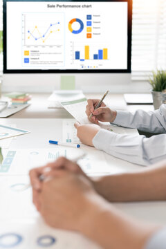 Business analysis and performance tracking with sale performance chart on screen.
