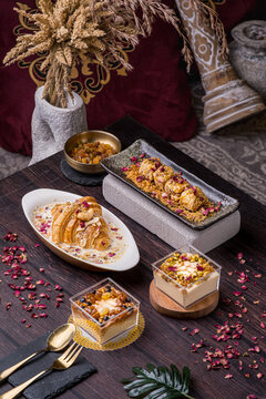 oum ali dessert, baklava, raisin pannacotta and almond pannacotta arranged neatly