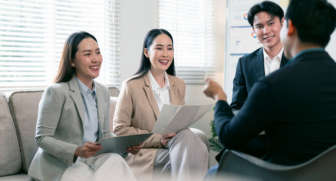 Asian business professionals having a productive meeting and discussion in office.