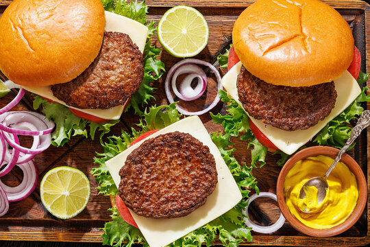beef cheeseburgers with brioche buns on a tray