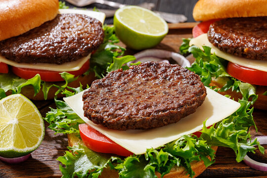 beef cheeseburgers with brioche buns on a tray