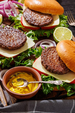 beef cheeseburgers with brioche buns on a tray