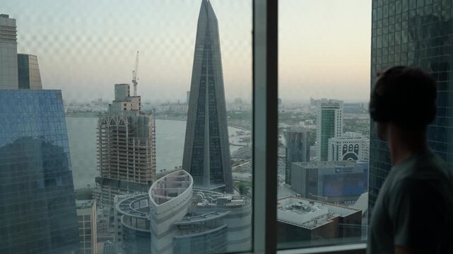 Static Shot Man with Headphones Overlooking Doha Skyline, Cinematic High-Rise Apartment View and Urban Lifestyle Qatar