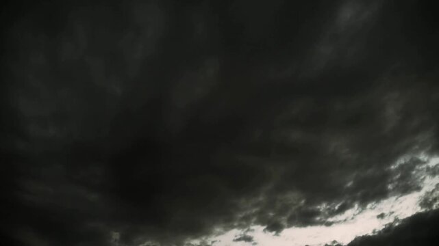Dark, stormy sky suitable for adding drama or tension in design projects. Great for weatherrelated content, backgrounds, or book covers.