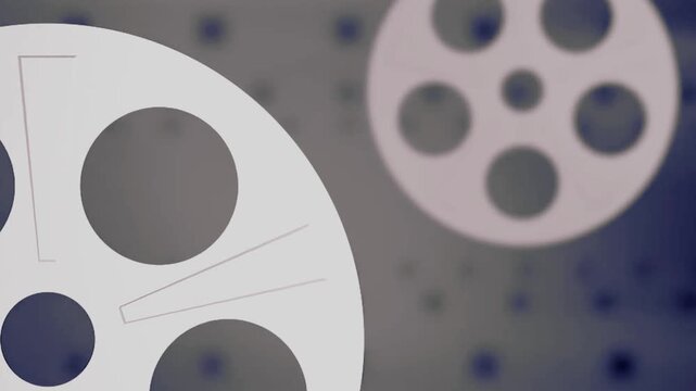 A close up of a metal film reel and projector on a black background featuring a round technology design pattern with a circular vector icon art symbol