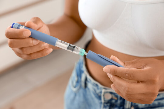 Woman with injection at home, closeup. Weight loss concept