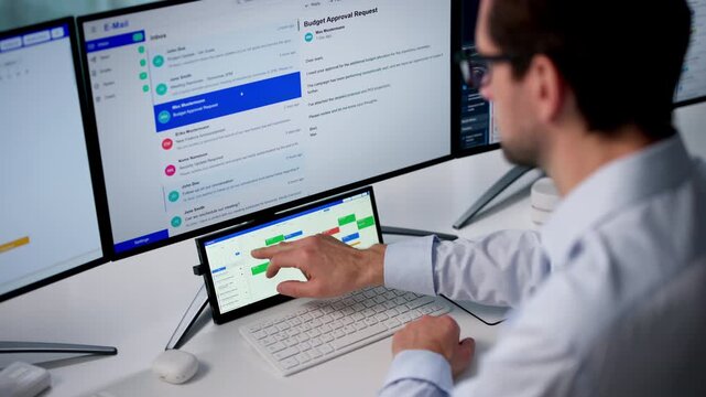 Man Checks His Online Calendar While Sending Emails