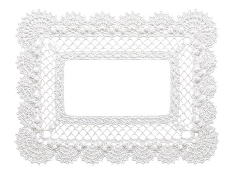 Delicate white crochet rectangular doily with ornate lacy border.