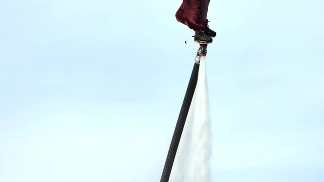 Flyboarding enthusiast performing extreme water sport with powerful water jets