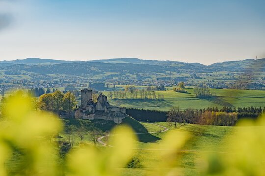 The historic castle ruins of Sulzberg in Allg&auml;u, Bavaria. Spring landscape with green hills and the Blender mountain with its radio tower in the background. Idyllic medieval heritage site.