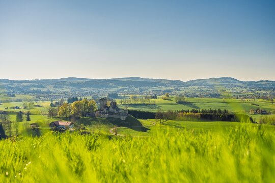 The historic castle ruins of Sulzberg in Allg&auml;u, Bavaria. Spring landscape with green hills and the Blender mountain with its radio tower in the background. Idyllic medieval heritage site.