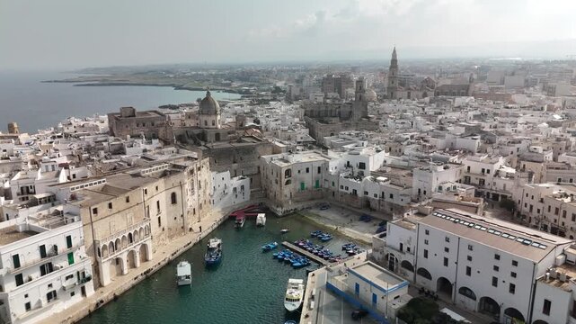 Aerial view of Monopoli old town with harbor, lighthouse and Adriatic coastline, Apulia, southern Italy