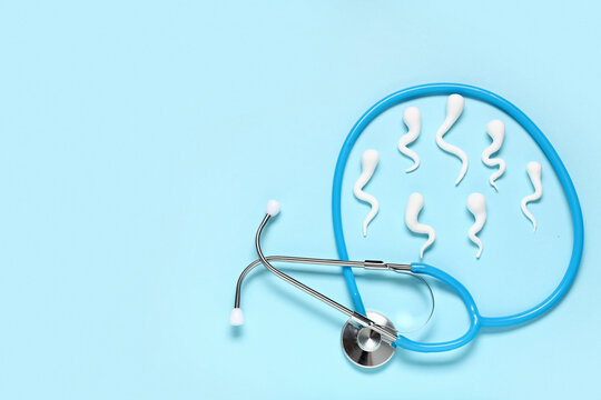 Sperm cells with stethoscope on blue background