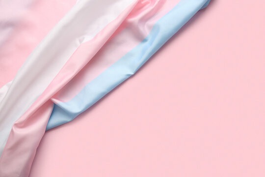 Transgender flag on pink background with space for text