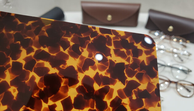 Polished Havana tortoiseshell acetate texture with backlit amber and brown pattern