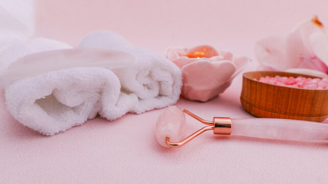 Rose quartz facial roller and spa essentials for a relaxing beauty ritual