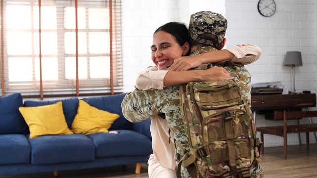 The family is happy; the father, an army soldier in his uniform and sunglasses, is preparing to go into battle. He bids farewell to his wife, who sits hugging him on a couch, crying sadly while he com
