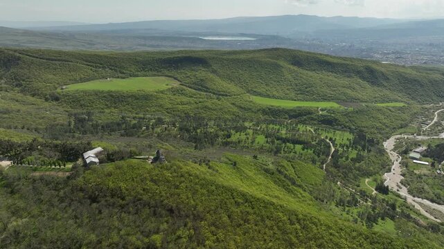 Aerial shot of the Mamkoda Monastery, located near Tbilisi. The image captures the historic stone architecture of the church and its surrounding monastic buildings