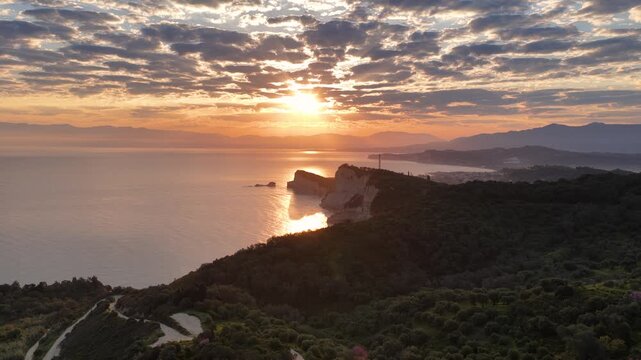 Aerial view of Cape Drastis cliffs at sunrise, beautiful golden hour over the Ionian Sea, Corfu island, Greece. Dramatic coastal landscape nature