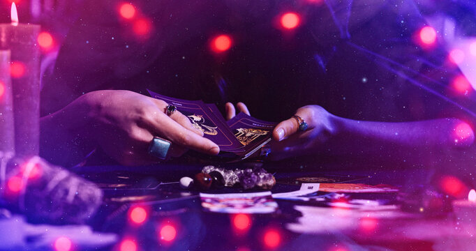 Female fortune teller reading tarot cards on table