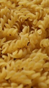 close up of a pile of uncooked fusilli pasta