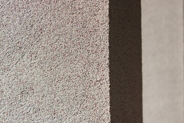 Bayramix mosaic plaster texture on house exterior wall © eliyashevskiy