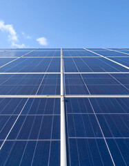 Obraz premium Solar panels in renewable energy field, photovoltaic system generating clean electricity in rural landscape under blue sky