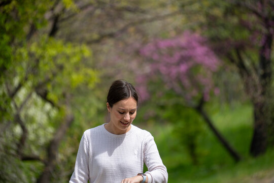 young woman walking in the spring park