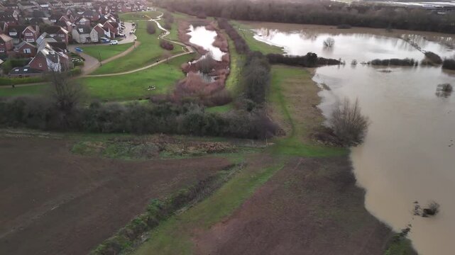 Aerial Close View of Riverside Homes Beside Flooded River in Barton Seagrave Northamptonshire