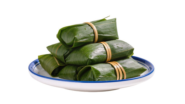 Wrapped rice parcels tied with string on blue rimmed plate