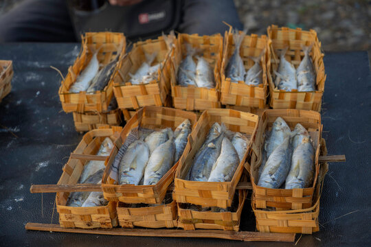 Fresh steamed mackerel fish known as ikan pindang in traditional bamboo baskets. Authentic Indonesian local market seafood preservation.