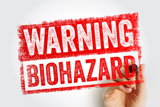 WARNING BIOHAZARD stamp message held by a person. Warning sign for biological threats, infection risks, and medical laboratory safety procedures