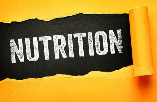 Nutrition word appearing through ripped paper. Ideal for food blogs, dietary advice, and health coaching materials. Emphasizing balanced eating and vitamin intake