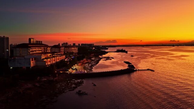 Aerial view of the Dusit Thani Mactan Cebu resort during an orange sunset in the Philippines.