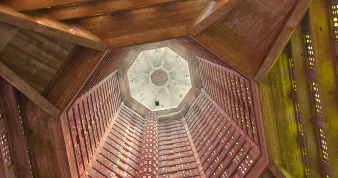Upward view inside St Joseph's Church octagonal tower in Le Havre, France. Post-WWII UNESCO architectural masterpiece rising 107 meters with wooden geometric ceiling.