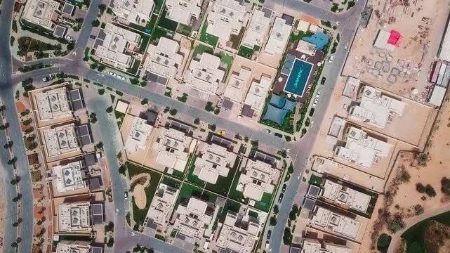 Top down drone descending over geometric residential neighborhood in Dubai