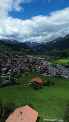Fototapeta premium Aerial view of Zweisimmen village surrounded by mountains, Switzerland