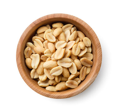 Salted roasted peanuts in a wooden bowl on a white background. Top view