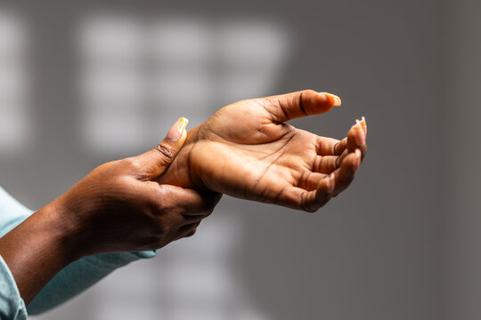 African woman grasping wrist feeling discomfort from pain