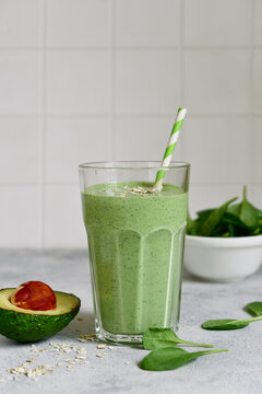 Detox avocado spinach smoothie in a tall glass. Top view with copy space.
